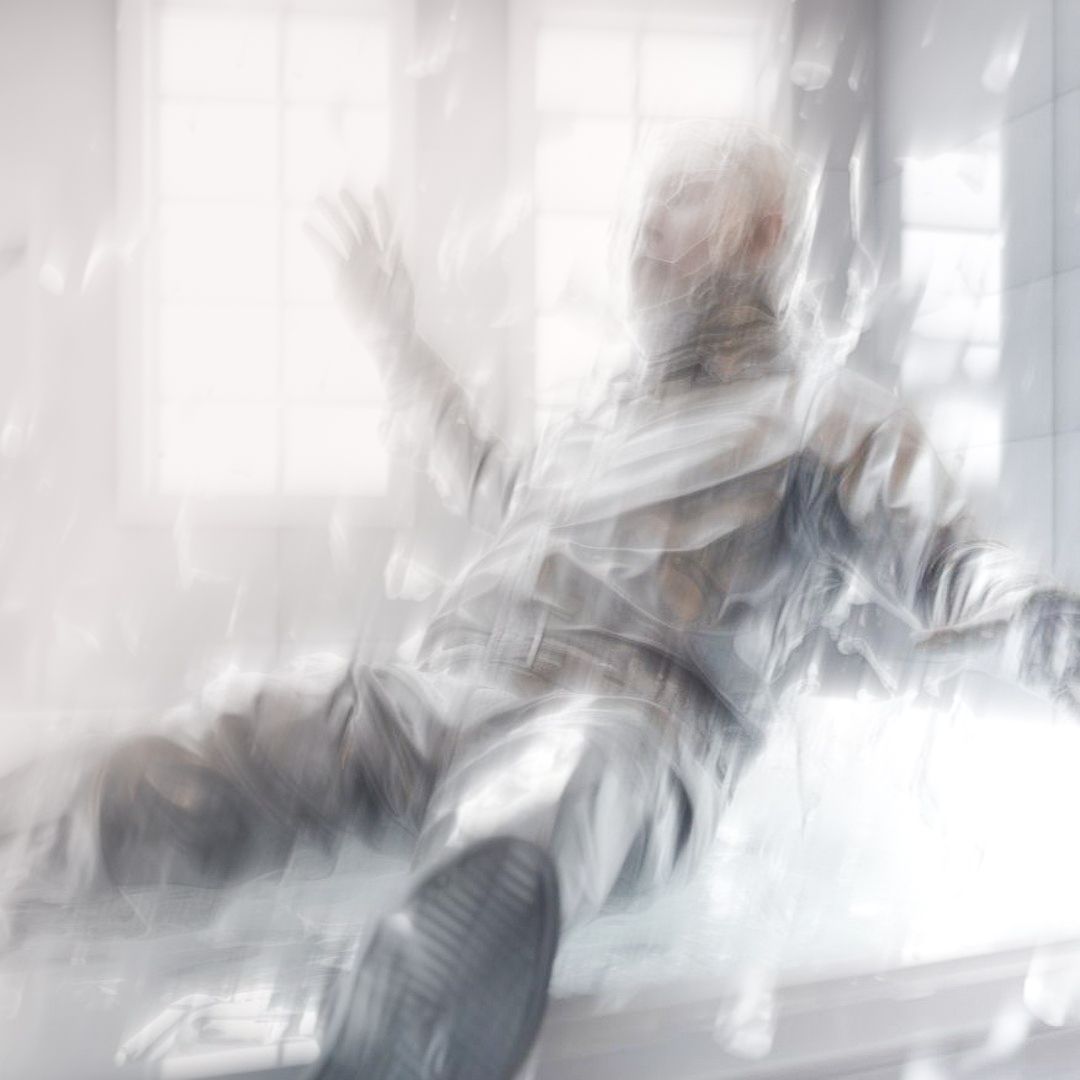 transcendental 3d animated man in bright laboratory like room falling down with glass shard but also plastic like particles all around him